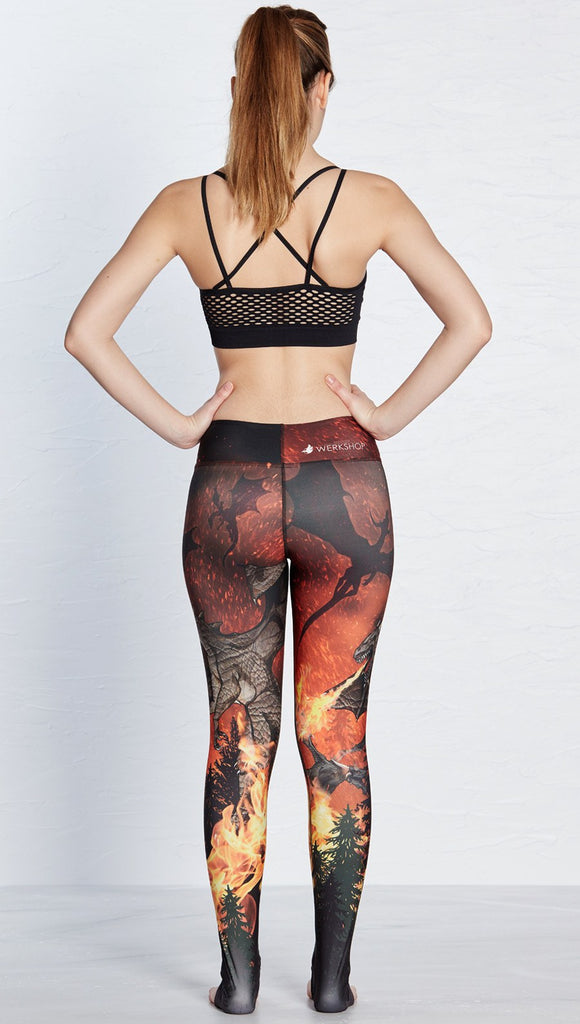 back view of model wearing fire breathing dragon themed printed full length leggings 