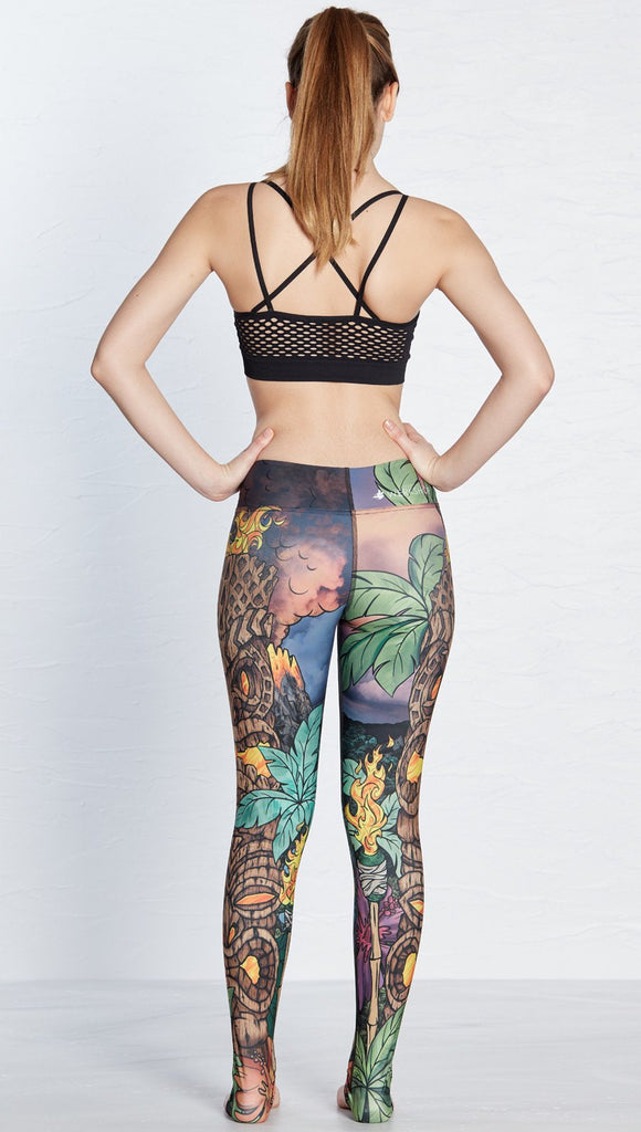 back view of model wearing island tiki themed printed full length leggings