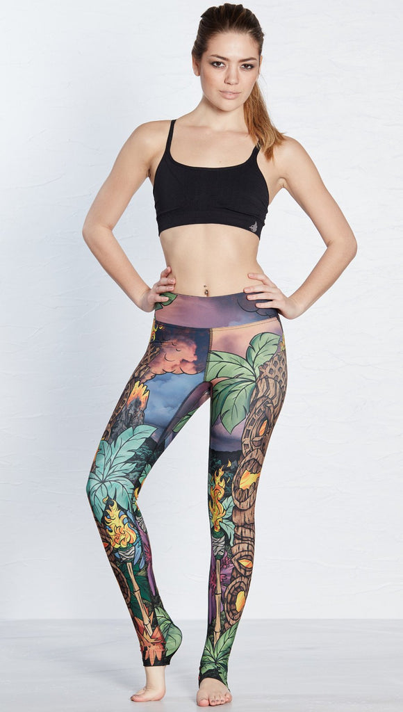 front view of model wearing island tiki themed printed full length leggings