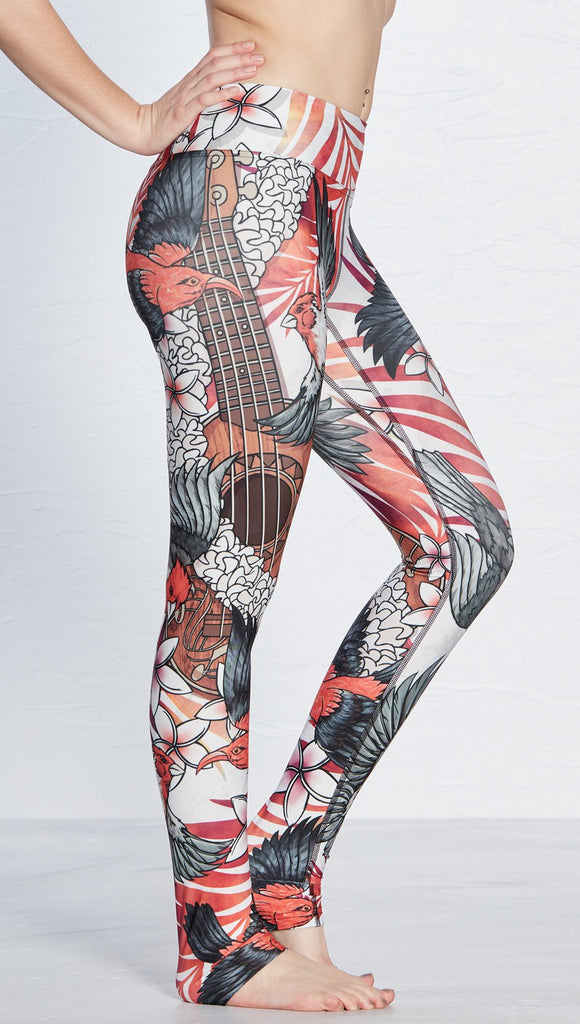 close up side view of model wearing vintage ukulele and bird themed printed full length leggings