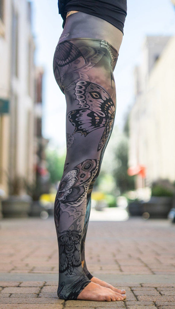 close up right side view of model wearing mashup gothic themed printed full length leggings
