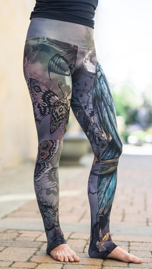 close up front side view of model wearing mashup gothic themed printed full length leggings