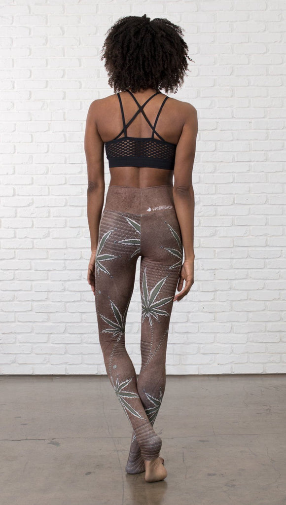 back view of model wearing cannabis leaf printed full length leggings