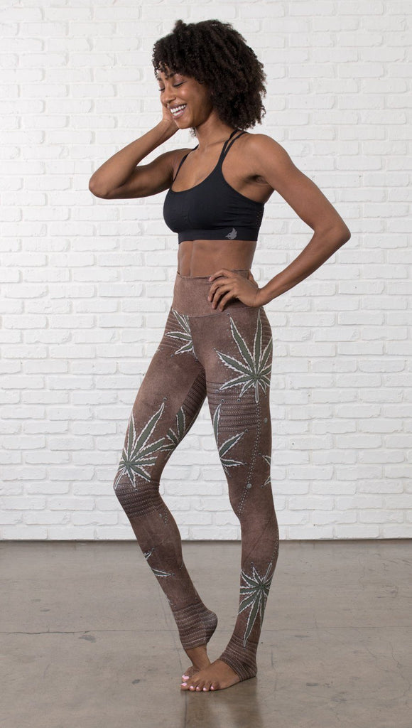 left side view of model wearing cannabis leaf printed full length leggings