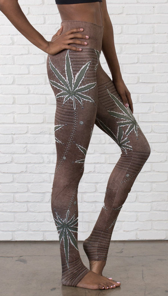 close up right side view of model wearing cannabis leaf printed full length leggings