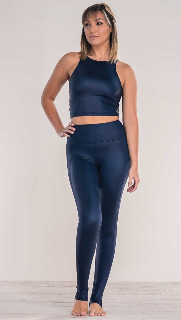 Front view of model wearing shiny midnight blue full length leggings with right side pocket