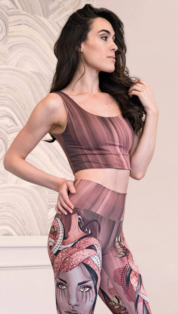 Right side view of model wearing a mauve color sleeveless crop top with black brushstrokes