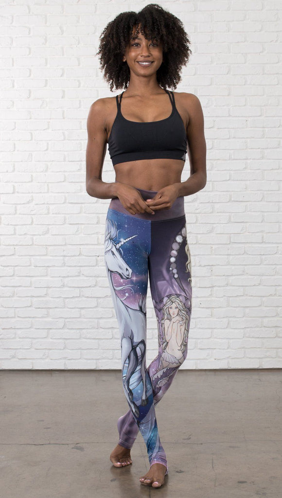 front view of model wearing full length leggings with unicorn and mermaid mashup printed design