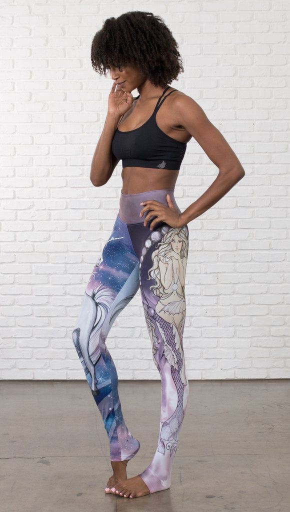 front view of model wearing full length leggings with unicorn and mermaid mashup printed design