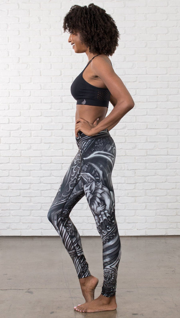 left side view of model wearing galaxy themed printed full length leggings
