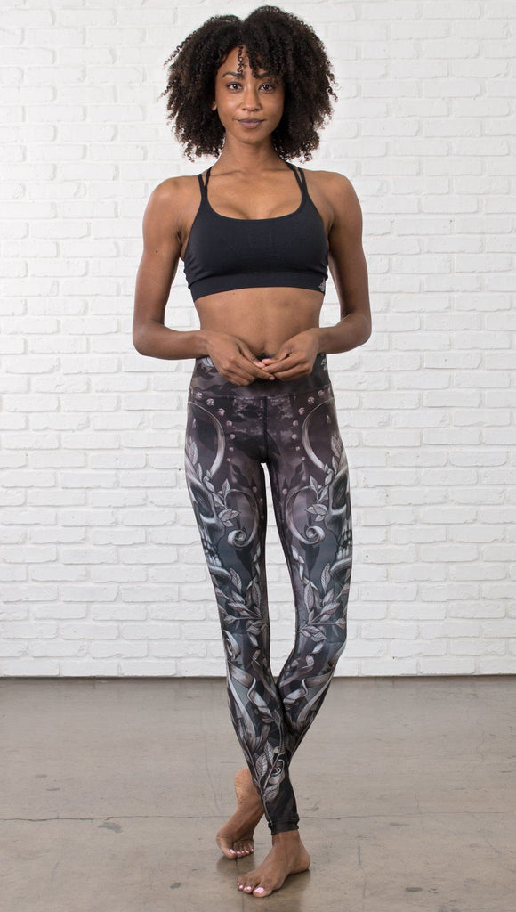 front view of model wearing gothic themed printed full length leggings
