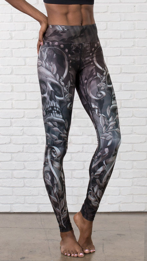 close up front view of model wearing gothic themed printed full length leggings