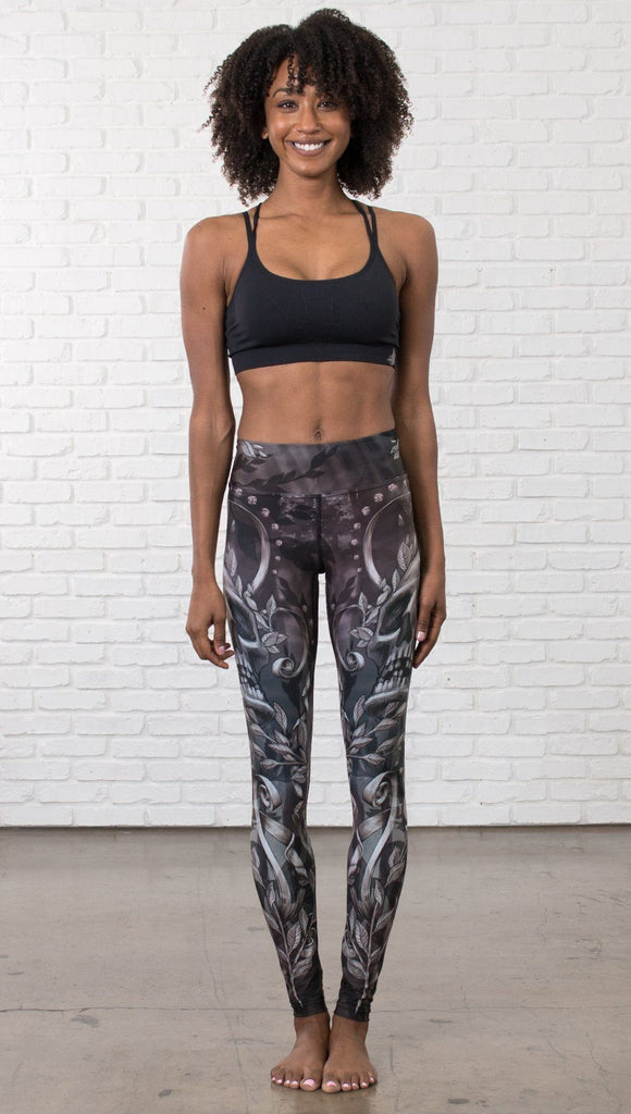 front view of model wearing gothic themed printed full length leggings