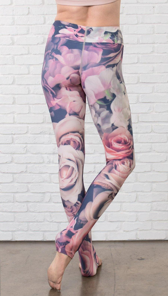 close up back view of model wearing romantic flower printed full length leggings