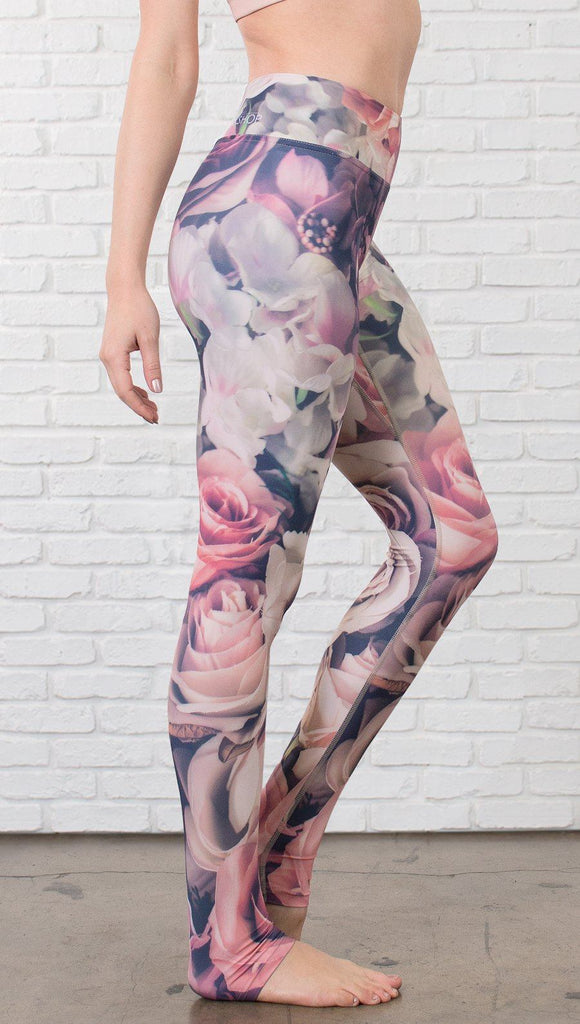 close up right side view of model wearing romantic flower printed full length leggings