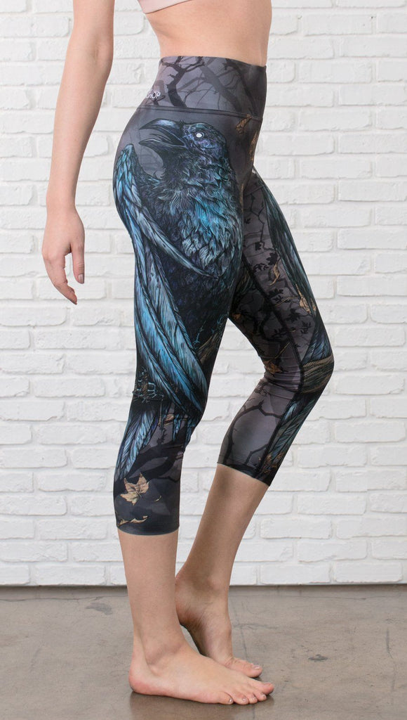 closeup right side view of model wearing gothic themed printed capri leggings