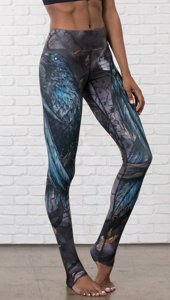 closeup front view of model wearing gothic themed printed full length leggings