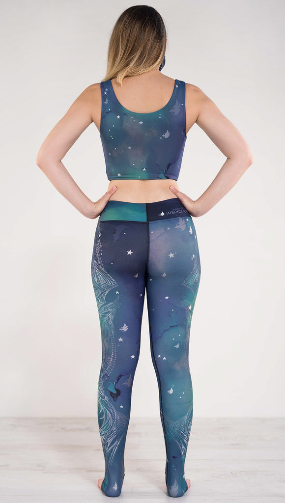 Back view of model wearing a blue and green galaxy themed triathlon leggings