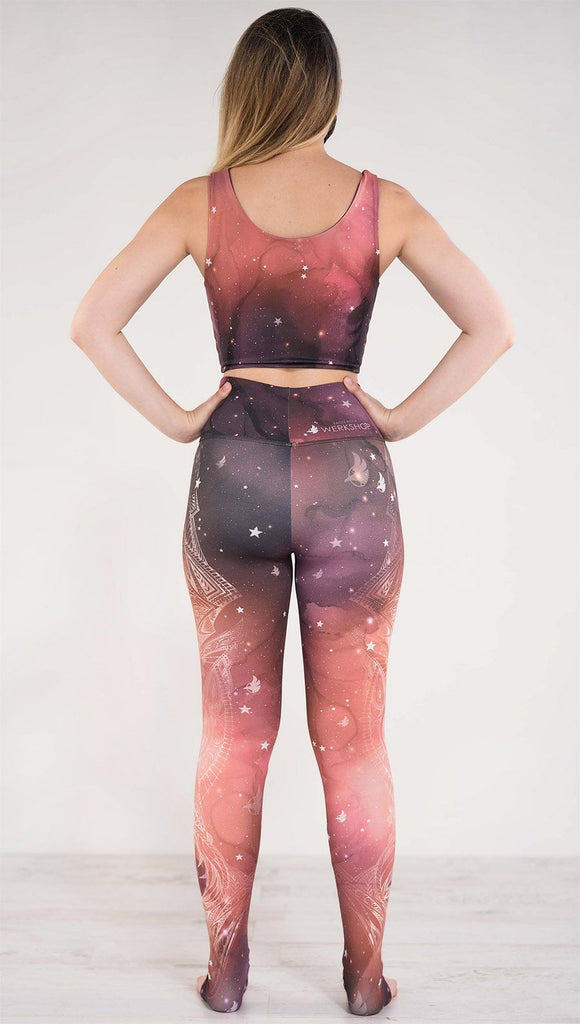 Back side view of model wearing a red, orange and purple galaxy themed athleisure leggings 
