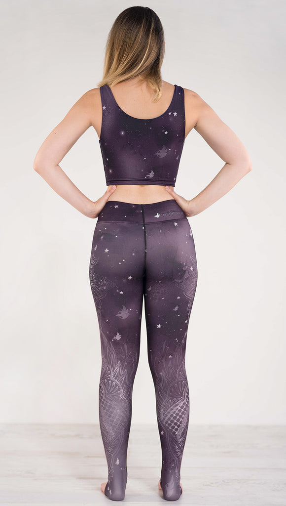 Back side view of model wearing purple galaxy themed triathlon leggings 