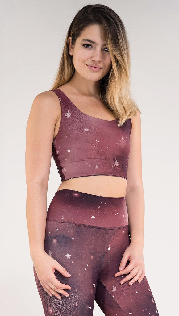 right side view of model wearing a merlot color galaxy themed reversible crop top called Galactic Merlot on this side