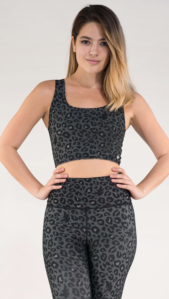Front view of model wearing the reversible Dragon/ Leopard top in the Charcoal Leopard side in the colors gray and black