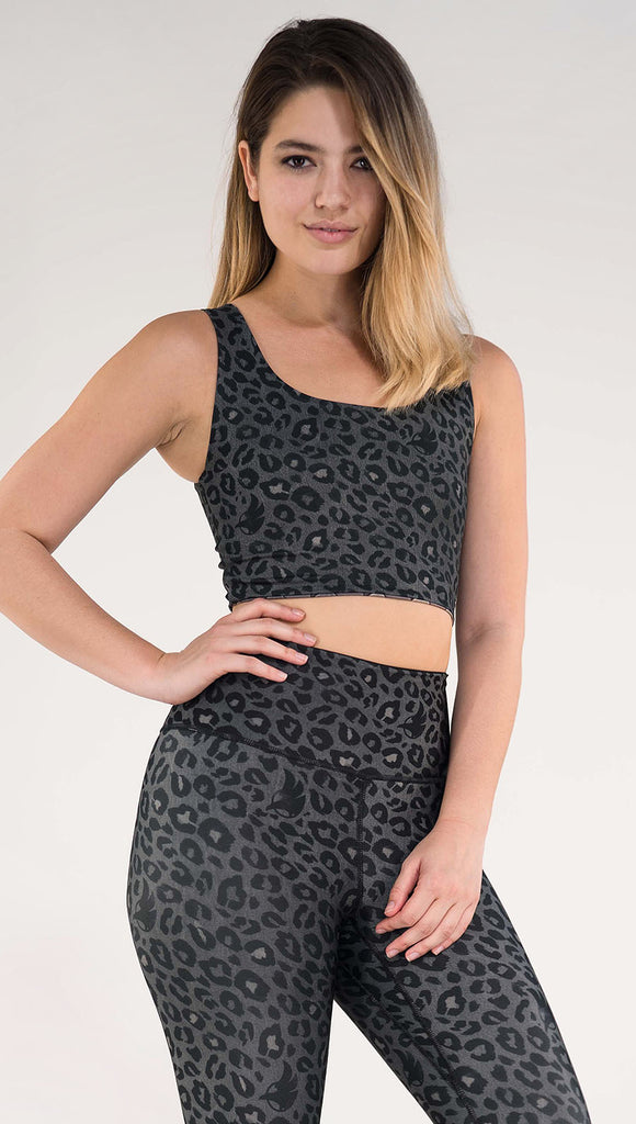 Front view of model wearing the reversible Dragon/ Leopard top in the Charcoal Leopard side in the colors gray and black