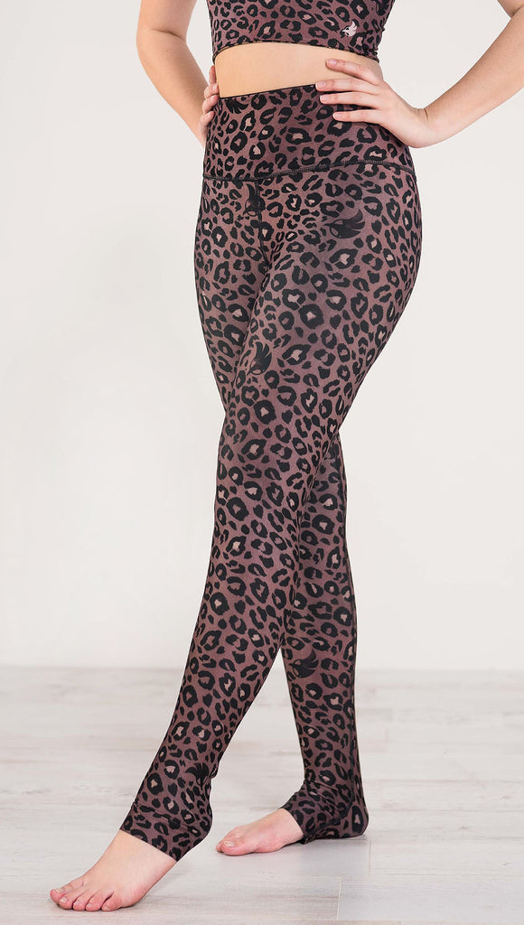 Left side view of model wearing the reversible red leopard print athleisure leggings in the colors dusty red and black