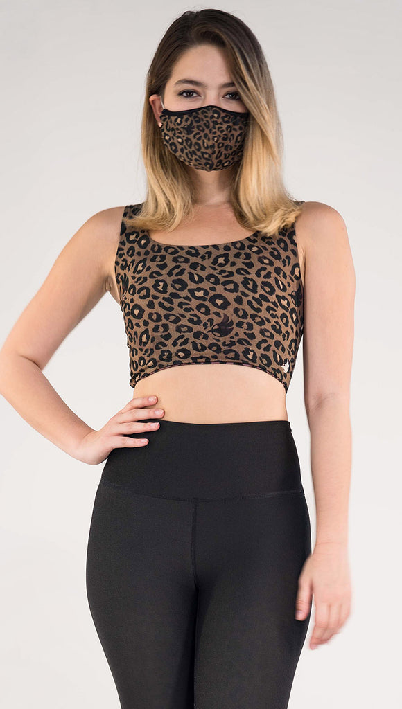 Front view of model wearing the Tan/ Red Leopard Top in the Tan Leopard side in the colors tan and black