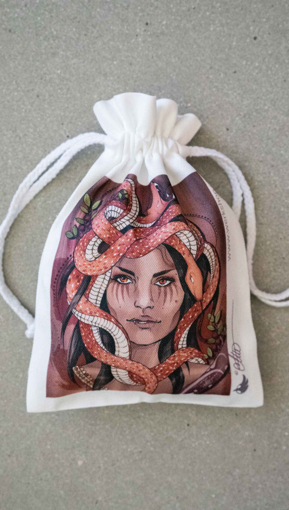 WERKSHOP Medusa canvas drawcord pouch (comes free with matching puzzle)! The artwork features medusa with her crown of snakes over a mauve background with berries and pops of green leaves.