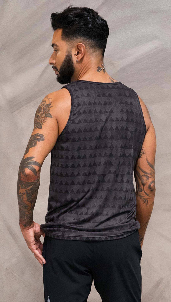 Close up back view of model wearing charcoal black printed tank top with distressed tribal inspired art