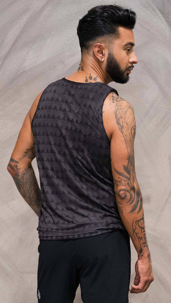 Close up back view of model wearing charcoal black printed tank top with distressed tribal inspired art