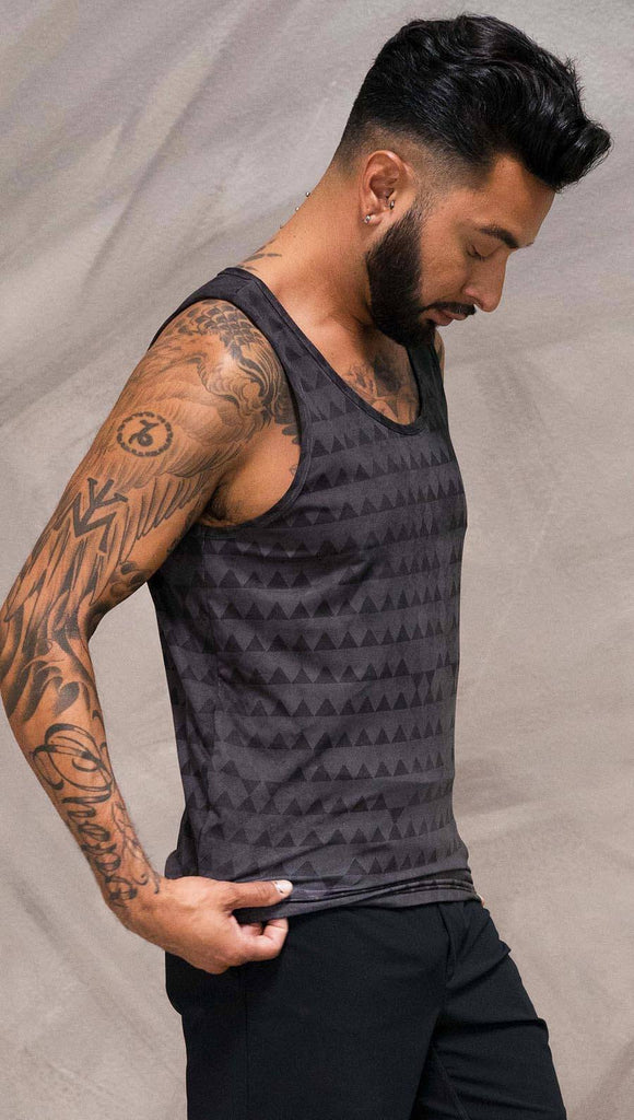Close up right side view of model wearing charcoal black printed tank top with distressed tribal inspired art