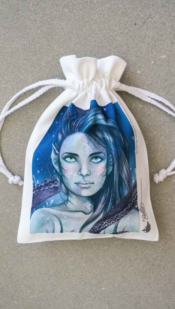 WERKSHOP Merbabe canvas drawstring pouch (comes free with matching puzzle)! The artwork features a mermaid with irridescent/rainbow inspired scales, blue hair and an octopus tentacles wrapping around her.