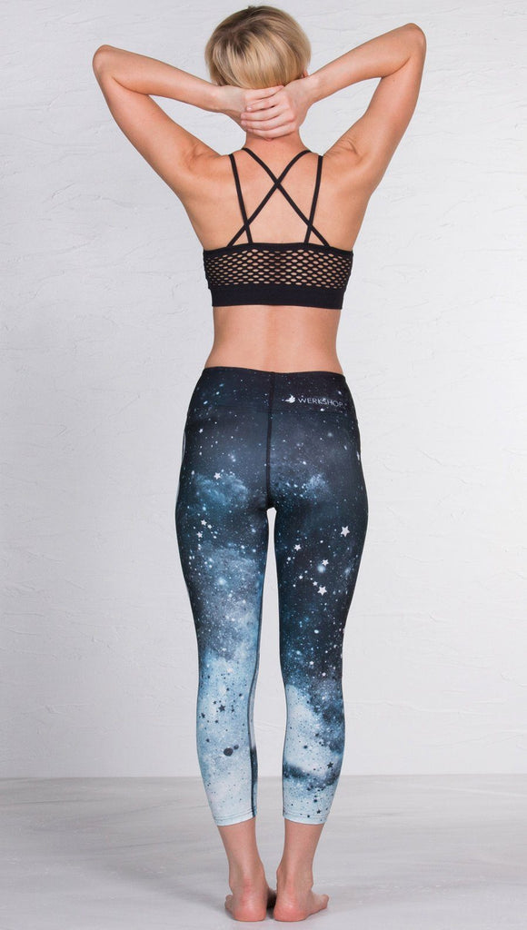 back view of model wearing moon cycle design printed capri leggings