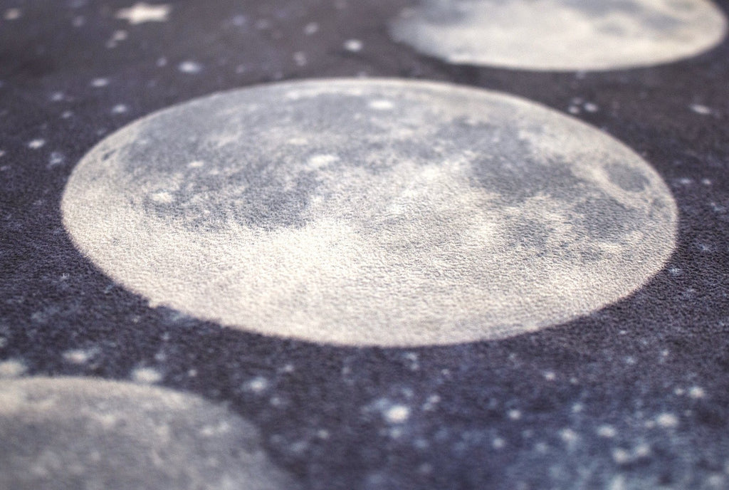 closeup view of moon cycle themed yoga mat design
