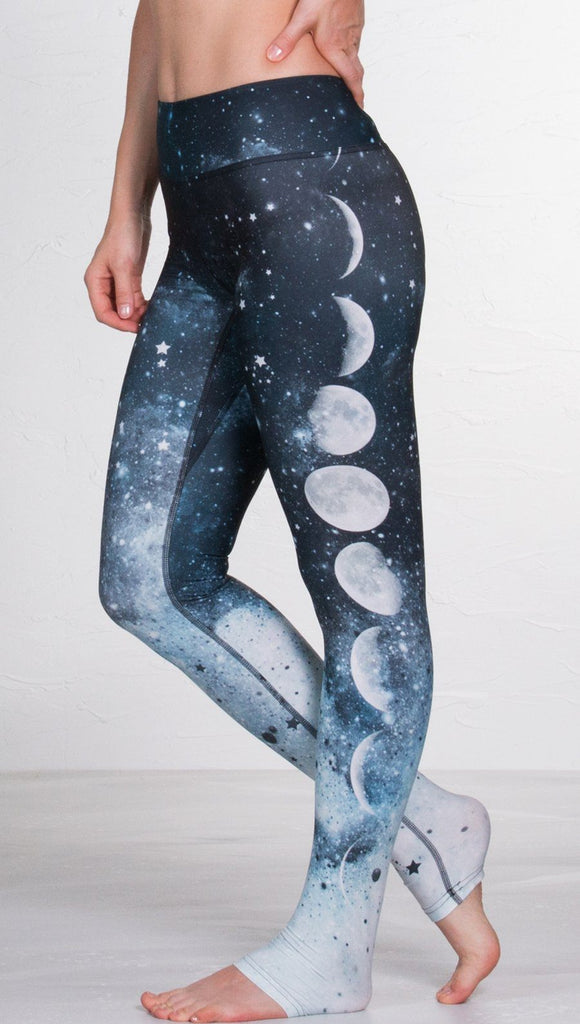 closeup left side view of model wearing moon cycle design printed full length leggings