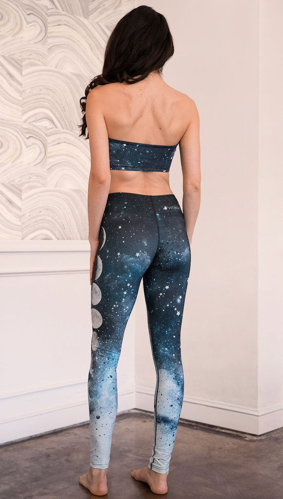 back view of model wearing moon cycle themed full length leggings