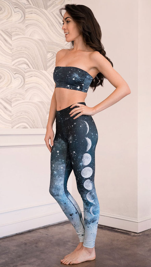left side view of model wearing moon cycle themed full length leggings