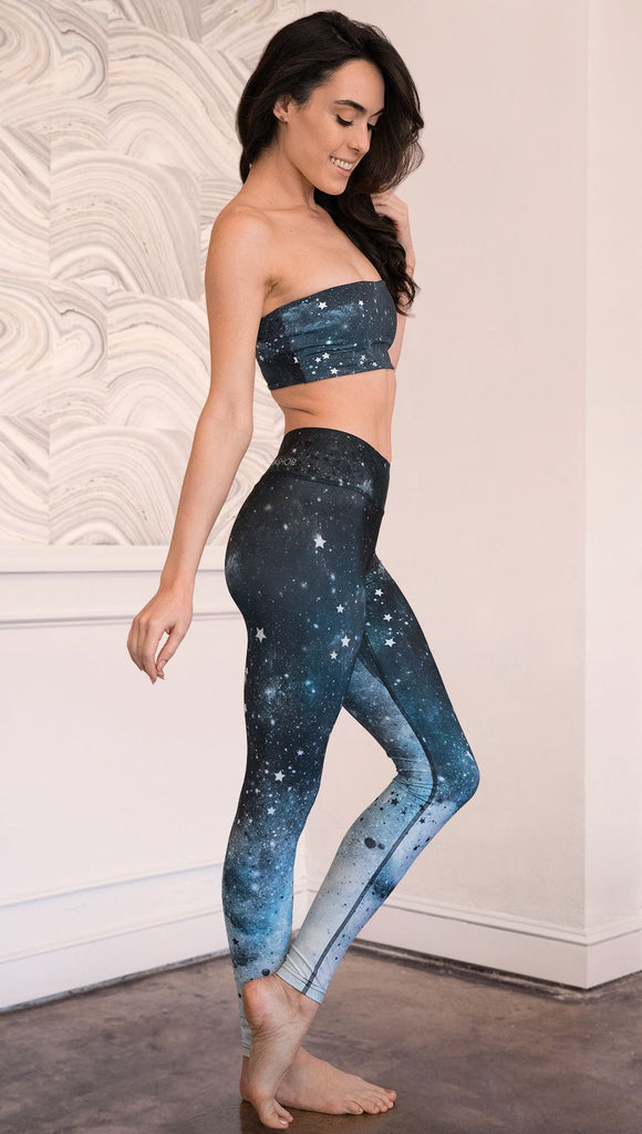 right side view of model wearing moon cycle themed full length leggings