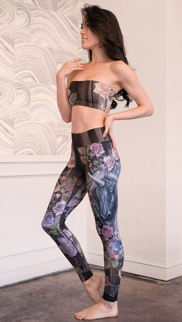 left side view of model wearing unicorn themed full length leggings