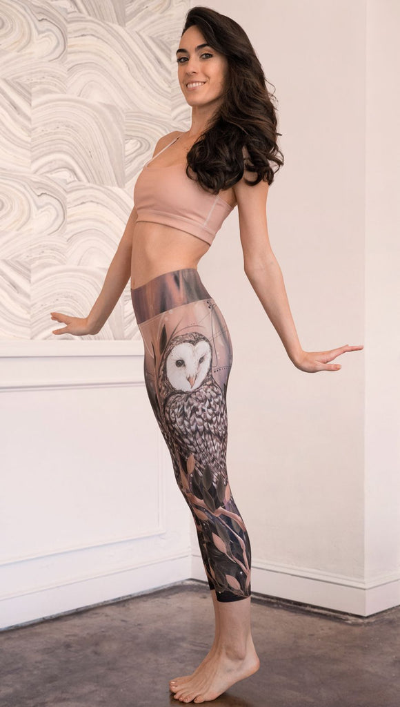 left side view of model wearing owl themed capri leggings