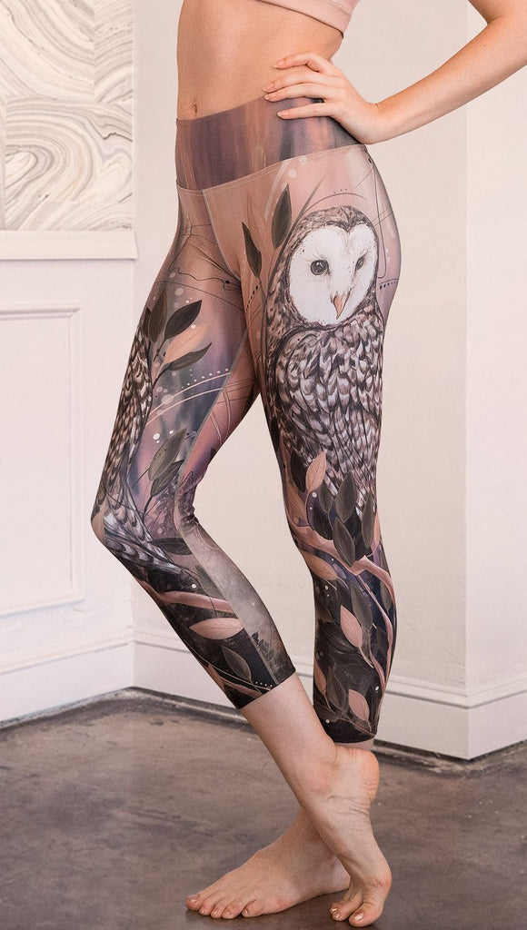 closeup left side view of model wearing owl themed capri leggings