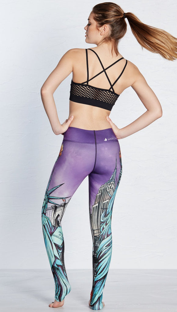 back view of model wearing new york themed printed full length leggings