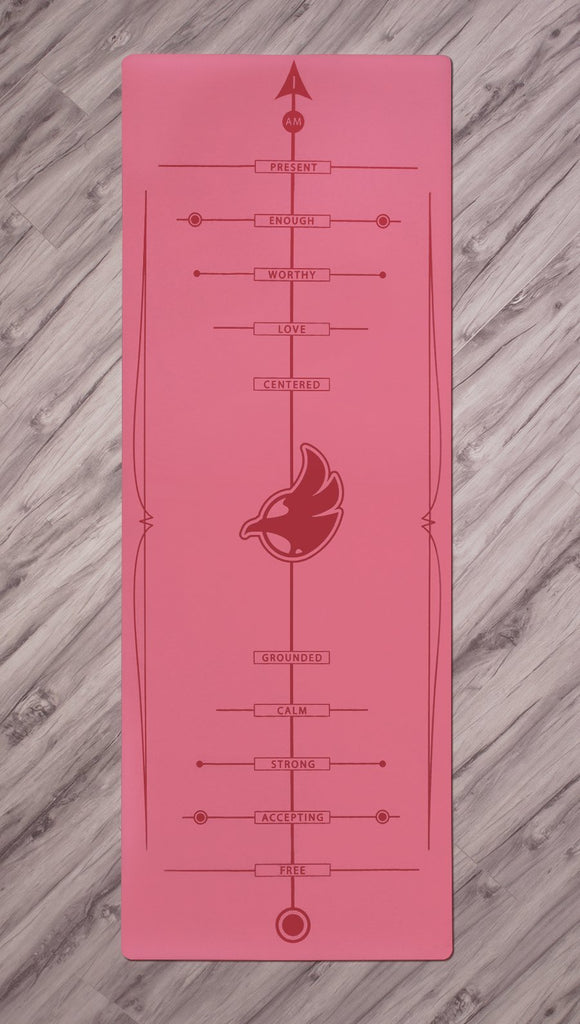 Top view of pink yoga mat with werkshop logo