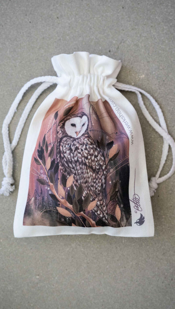 Canvas dawstring pouch featuring WERKSHOP Barn Owl Artwork ~ comes free with matching puzzle.. The puzzle is printed with original artwork of an Owl by Chriztina Marie. It features a barn owl perched on top of a branch with whimsical leaves. The overall color story is of mauves, warm browns and complimentary green leaves. 