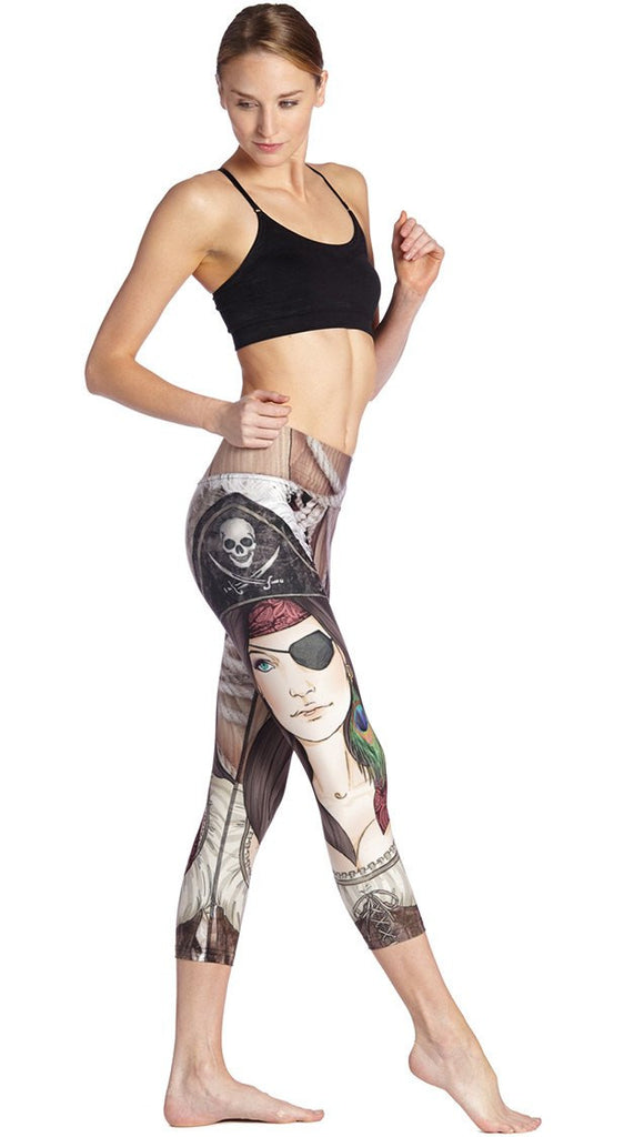 right side view of model wearing pirate girl themed printed capri leggings