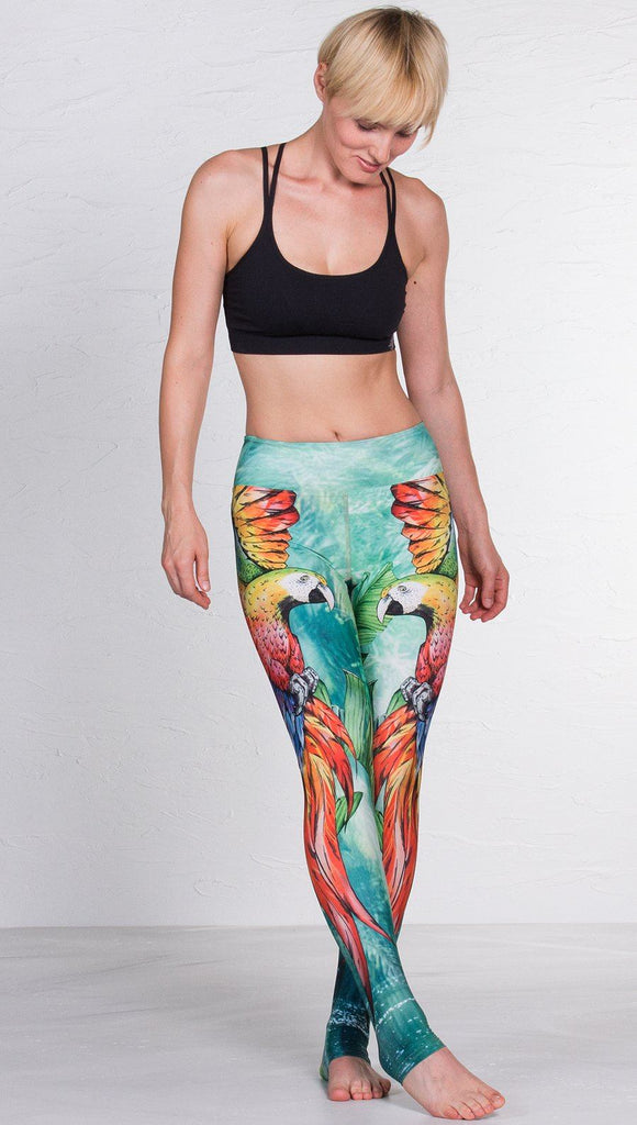 front view of model wearing macaw themed full length leggings