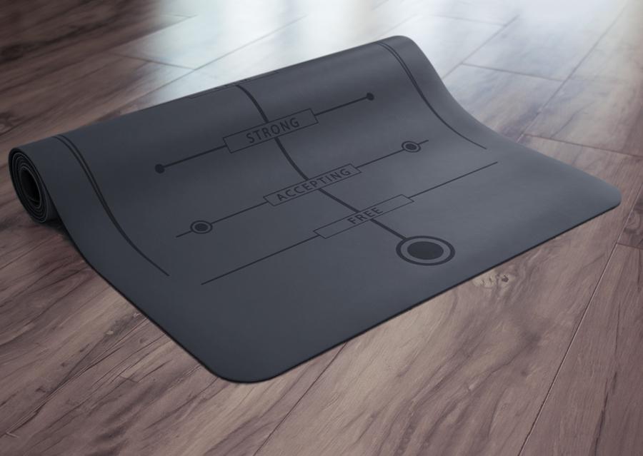 Partially rolled black yoga mat on floor