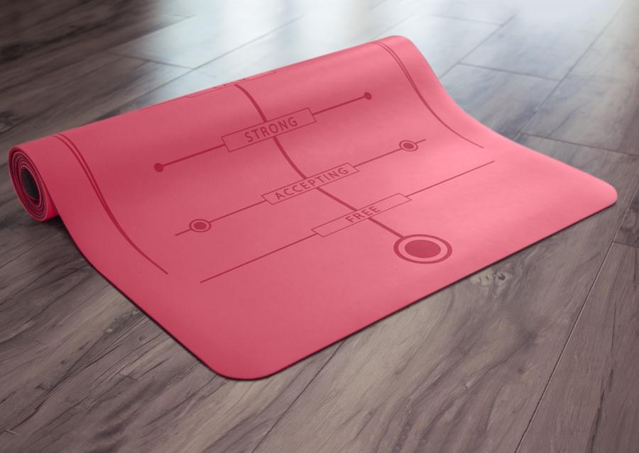 Partially rolled pink yoga mat on floor